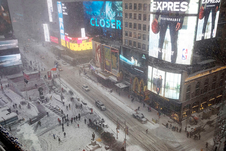 Snow falls in Times Square on Jan. 4, 2018, in New York.