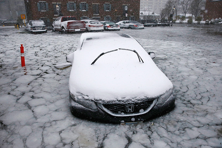 A car sits in floodwaters from Boston Harbor on Jan. 4, 2018.