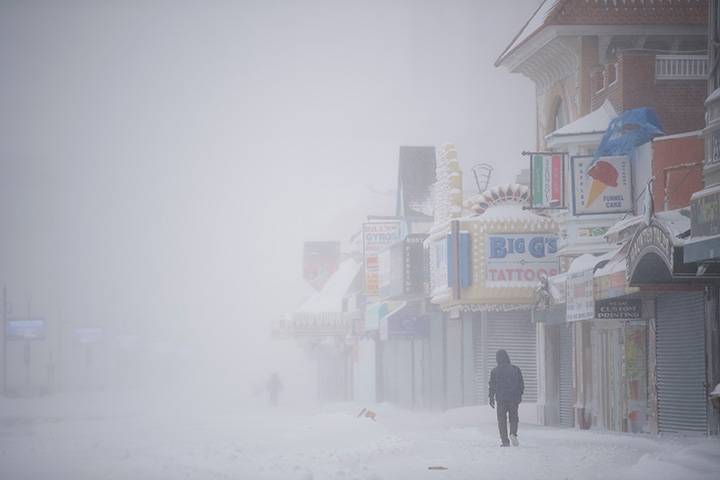 A man walks on the snow covered boardwalk during a storm on January 4, 2018 in Atlantic City, New Jersey.