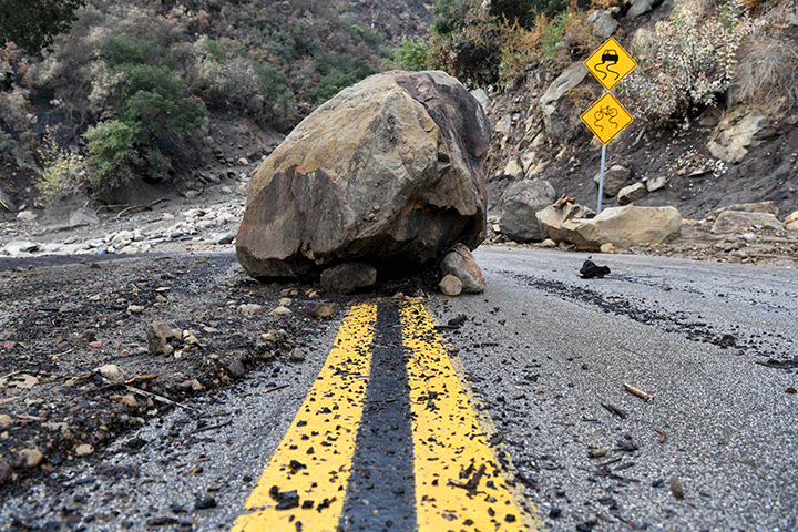 A large boulder sits in the middle of Bella Vista Drive in Montecito, Calif., following a rain storm, Tuesday, Jan. 9, 2018.