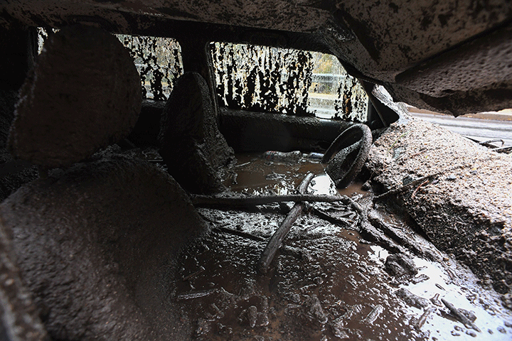Mud fills the interior of a car destroyed in a rain-driven mudslide in Burbank, Calif., Jan. 9, 2018.