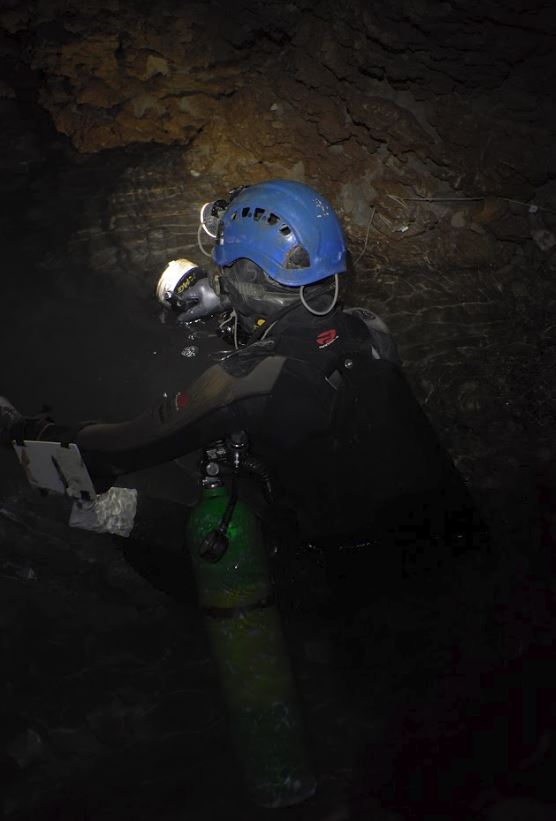 Explorer Katie Graham wears scuba gear while exploring new depths of the Bisaro Anima cave. (2018)