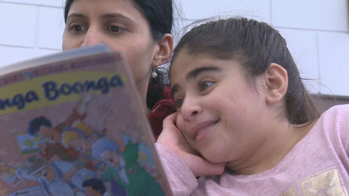 A mother and daughter bond over a book on Family Literacy Day.