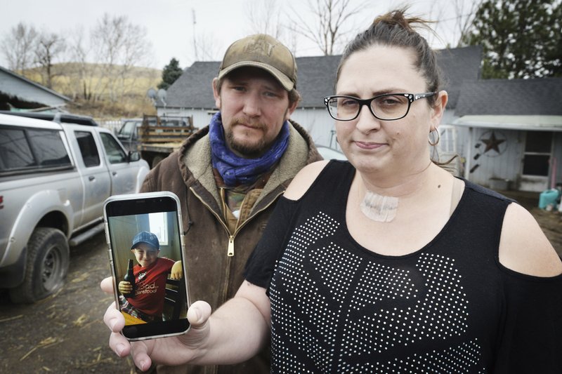 Scott Hinkle, left, and Sara Hebard, lost their son, Liam Flanagan, 8, pictured in the cell phone photo, on Jan. 21 after an eight-day battle with a flesh-eating bacteria.