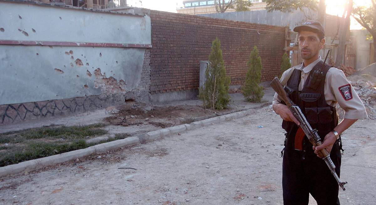 KABUL, AFGHANISTAN:  An Afghan security officer stands guard outside the Canadian embassy in Kabul, on Oct. 12, 2005.  