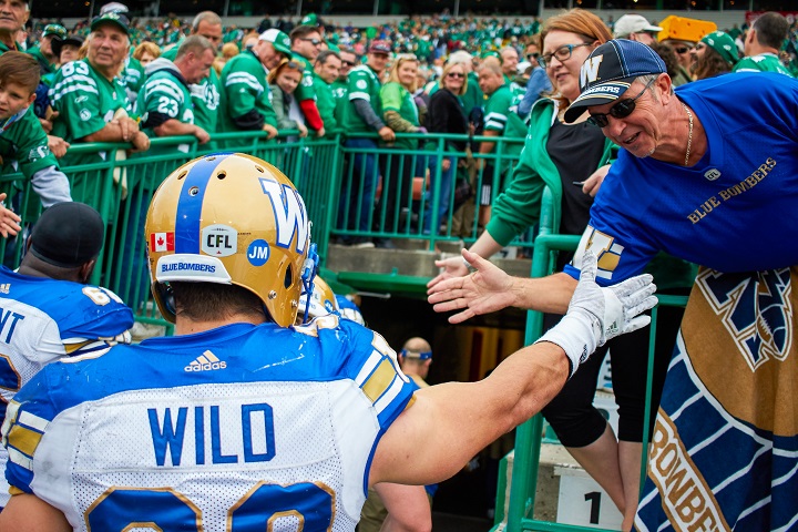 A Winnipeg Blue Bomber fan congratulates Ian Wild after the Bombers defeated the Saskatchewan Roughriders on Sept. 4, 2016 for their first Labour Day Classic win in 11 years.