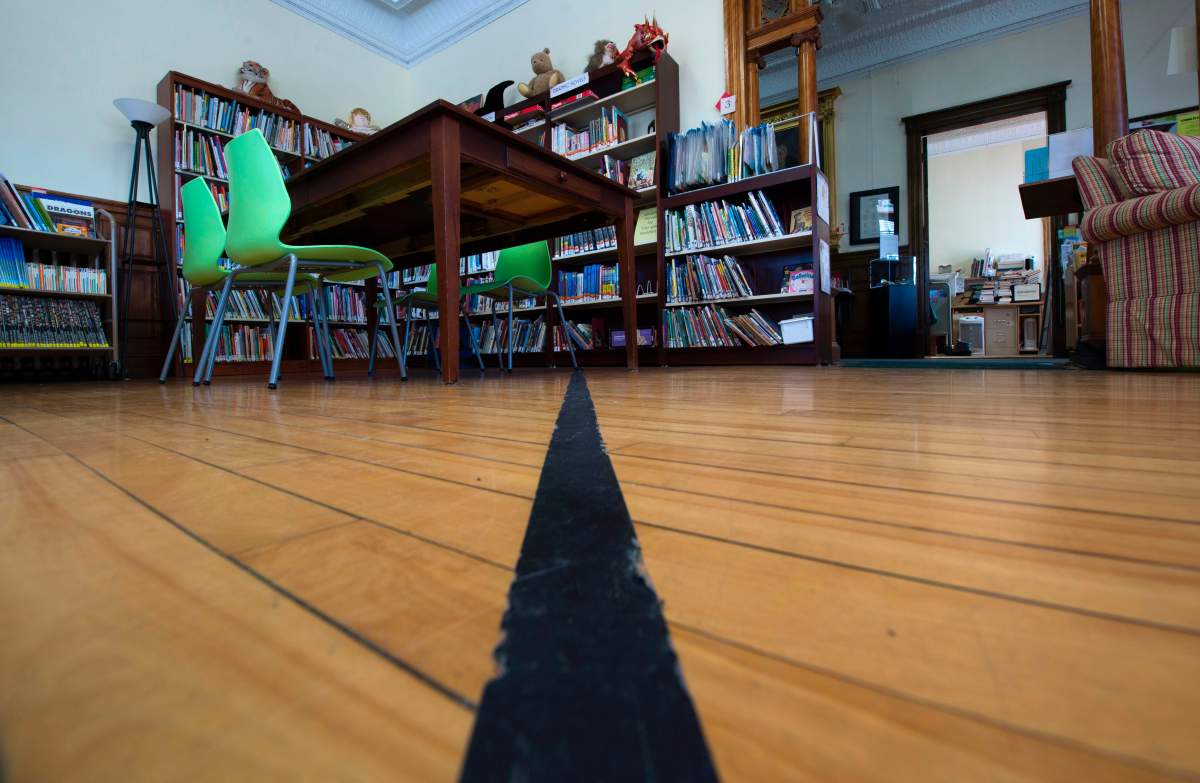 Black tape marks the U.S.-Canada border inside the Haskell Free Library and Opera House.