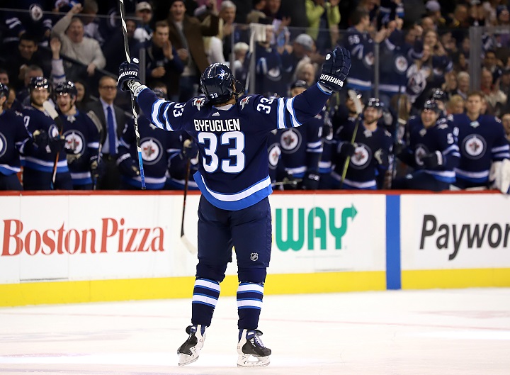 Dustin Byfuglien of the Winnipeg Jets raises his arms in celebration after scoring a first period goal against the Buffalo Sabres.