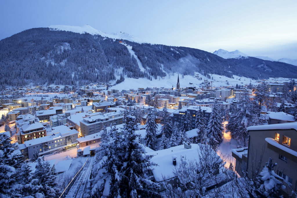St. John’s church, centre right, sits surrounded by snow-covered residential buildings as night falls in Davos, Switzerland, on Monday, Jan. 18, 2015. President Donald Trump will dominate the Davos forum as no U.S. leader has before: a provocateur-in-chief practiced at tweaking the elites wholl gather later this month to celebrate the global order he seems eager to tear down. Trump would be the first sitting American president to attend the meeting of bankers, corporate chiefs, academics and investors since Bill Clinton in January 2000.