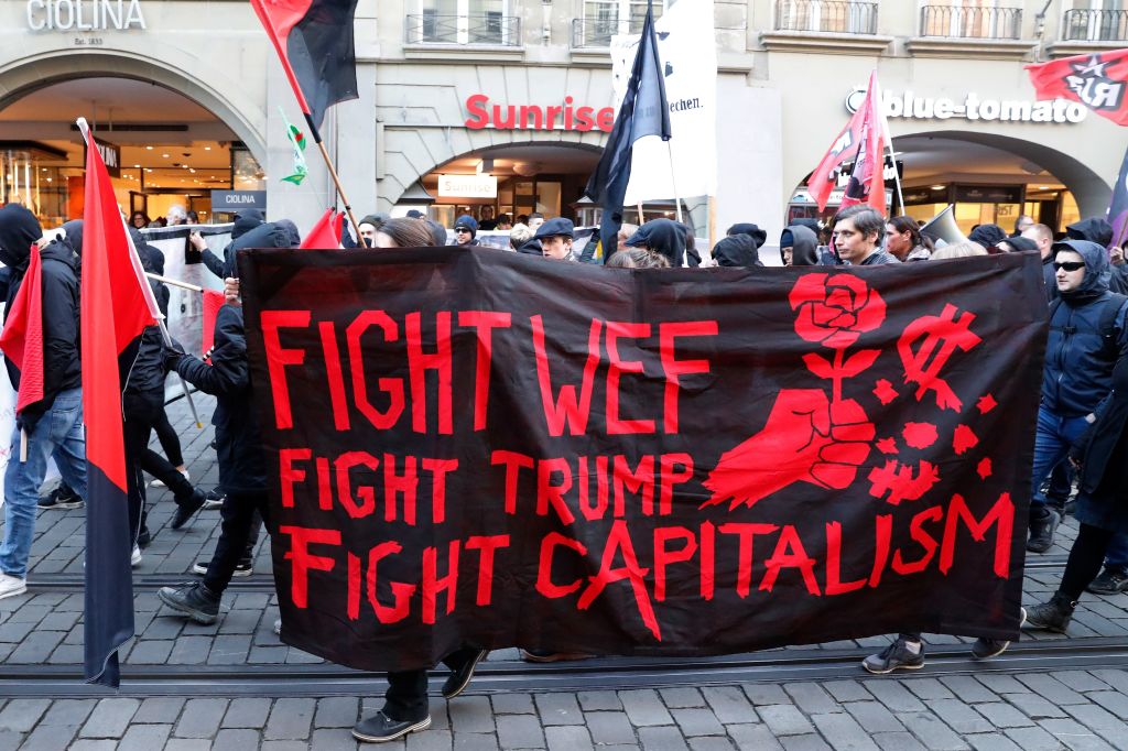 People take part in a protest against the planned visit of the US president to the World Economic Forum in Davos, in Bern on January 13, 2018.Swiss authorities on January 11 warned about unauthorised and potentially violent protests targeting this year’s World Economic Forum in Davos and its star attraction, US President Donald Trump. The annual meeting of the world’s political and business elite at the luxury Swiss ski resort often draws small protests against its famous participants and the global trade agenda.