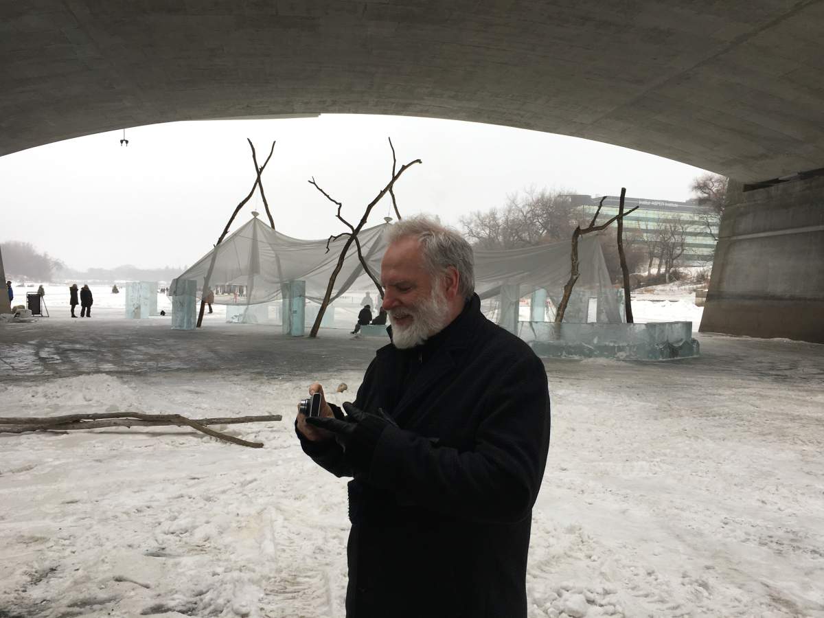 Guy Maddin takes pictures of his warming hut under the Norwood Bridge in this 2018 file photo.