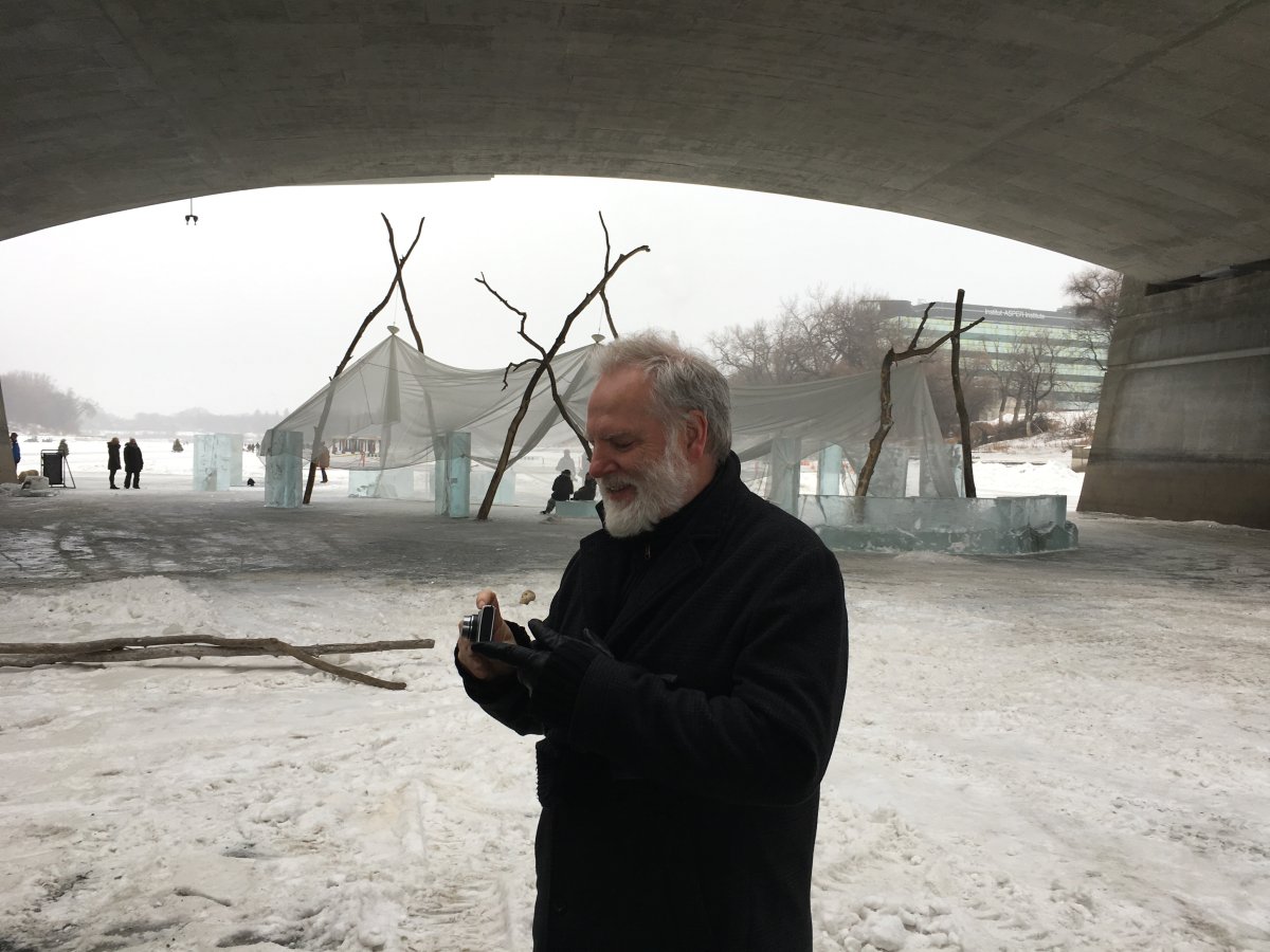 Guy Maddin takes pictures of his warming hut under the Norwood Bridge in this 2018 file photo.