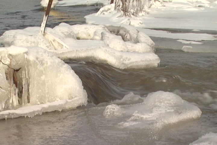 Water pours through an ice jam at Wilton Creek in Loyalist Township.