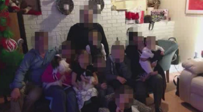 A photo of J.P., some family members, and her four children. 