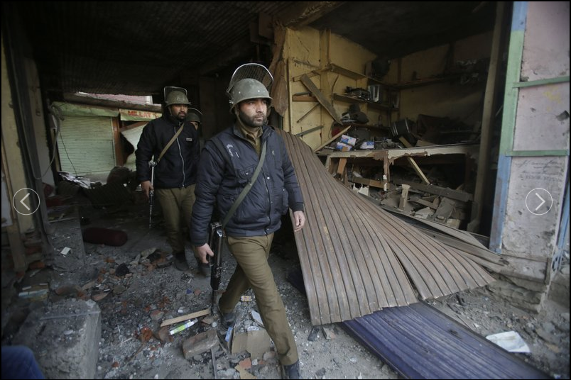 Policemen arrive to inspect the site of explosion in Sopore 55 kilometers (34 miles) north of Srinagar, Indian controlled Kashmir, Saturday, Jan. 6, 2018. Four policemen were killed Saturday when rebels fighting against Indian rule in disputed Kashmir detonated a bomb on a street they were patrolling, police said. 