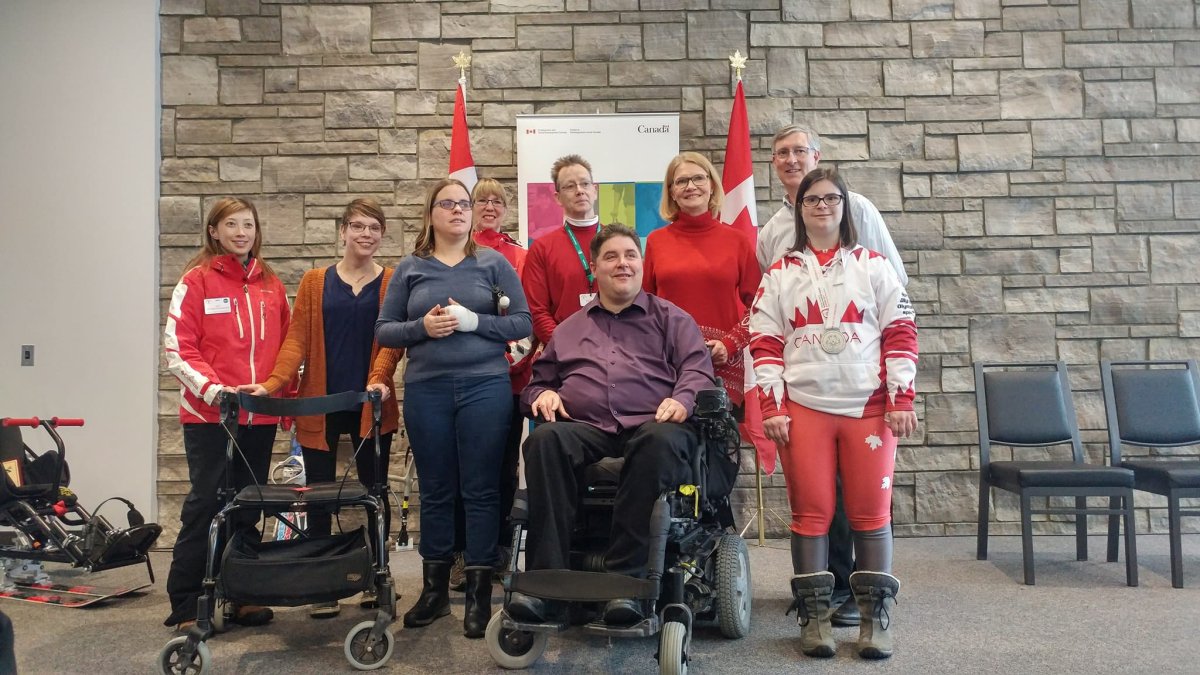 Minister of Sport and Persons with Disabilities, Kent Hehr, poses for a photo with MP Kate Young, members of the London Track 3 Ski School, and a Canadian Paralympic athlete.   