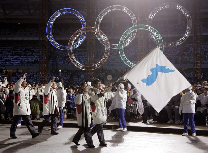 In this Feb. 10, 2006 file photo, Korea flag-bearer's Bora Lee and Jong-In Lee, carrying a unification flag, lead their teams into the stadium during the 2006 Winter Olympics opening ceremony in Turin, Italy. 