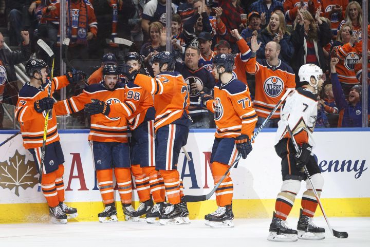 Anaheim Ducks' Andrew Cogliano (7) skates past as the Edmonton Oilers celebrate a goal during second period NHL action in Edmonton, Alta., on Thursday January 4, 2018. 