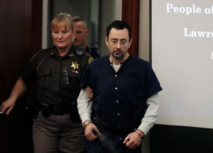 Dr. Larry Nassar is escorted into court during the seventh day of his sentencing hearing Wednesday, Jan. 24, 2018, in Lansing, Mich. 