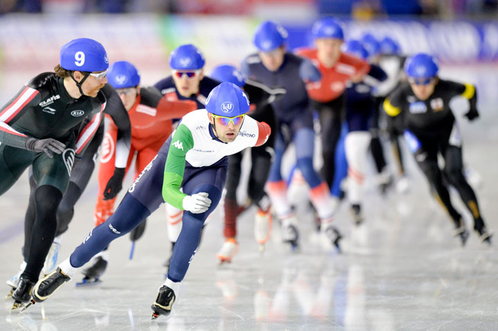 Olivier Jean (L) of Canada and Andrea Giovannini (C) of Italy lead the Mass Start race at the ISU Speed Skating World Cup in Calgary, on Dec. 3, 2017.