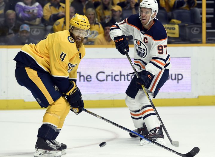 Edmonton Oilers centre Connor McDavid (97) shoots the puck past Nashville Predators defenceman Ryan Ellis (4) during the first period of an NHL hockey game Tuesday, Jan. 9, 2018, in Nashville, Tenn. 