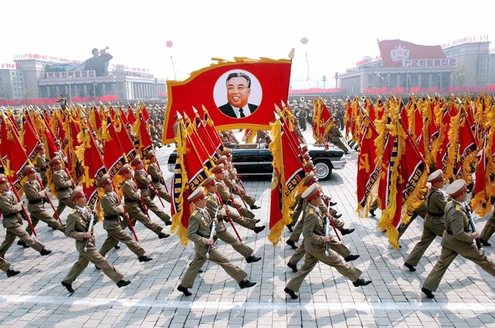 This 25 April 2007 picture, released from Korean Central News Agency 26 April, shows North Korean soldiers, carrying a large portrait of late North Korean leader Kim Il Sung, marching during a grand military parade to celebrate the 75th founding anniversary of the KPA at the Kim Il Sung square in Pyongyang. Kim Jong Il,  North Korean leader at the time, inspected the parade. 