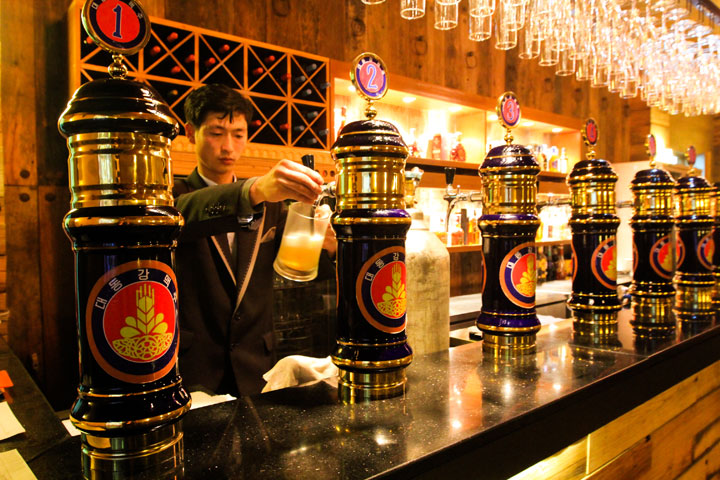 A North Korean bartender fills a mug of beer at an upscale pub on Jan. 27, 2014, in the capital Pyongyang, North Korea. The pub serves seven varieties of a North Korean beer called Taedonggang, named after the main river that runs through Pyongyang.