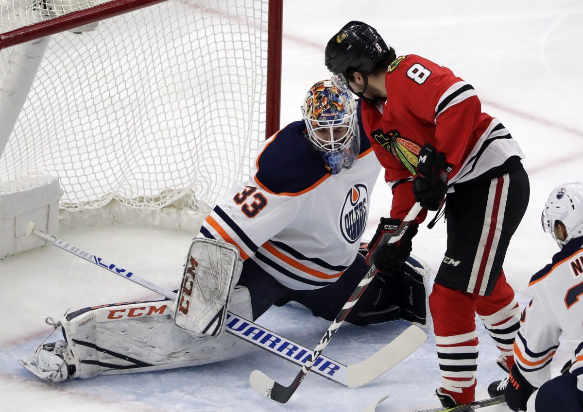Chicago Blackhawks center Nick Schmaltz, right, scores against Edmonton Oilers goalie Cam Talbot during the first period of an NHL hockey game Sunday, Jan. 7, 2018, in Chicago. 