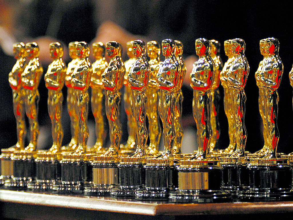 A row of Academy Awards statuettes (a.k.a. Oscars).