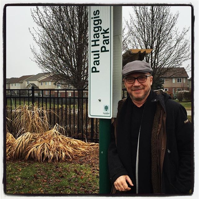 Paul Haggis poses in front of the Paul Haggis Park sign Jan. 20, 2017.