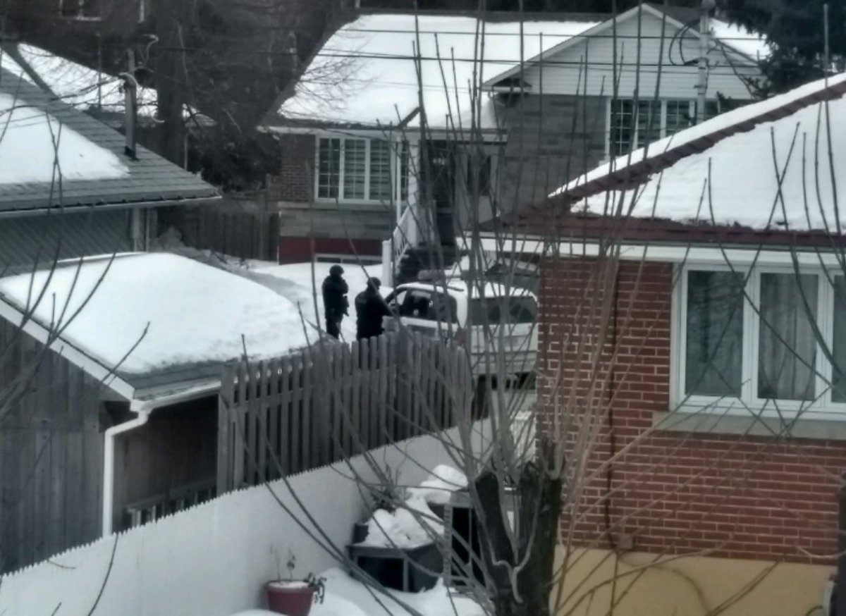 Police respond after they say a man barricaded himself inside his home in Pointe-Claire, Weds. Jan. 31, 2018.