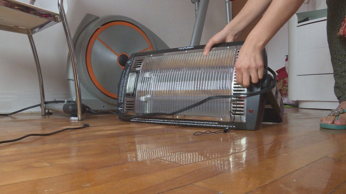 A tenant turns on a space heater in her Parc Extension apartment after complaining that the heat was too low.  