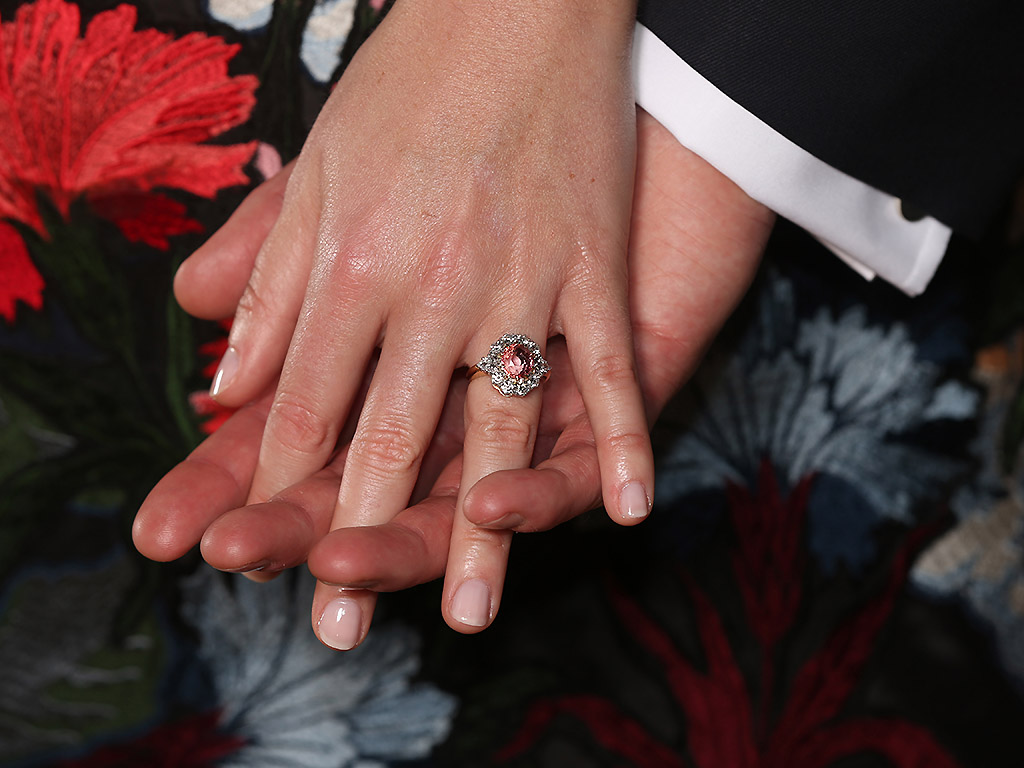 Princess Eugenie wears a ring containing a padparadscha sapphire surrounded by diamonds.