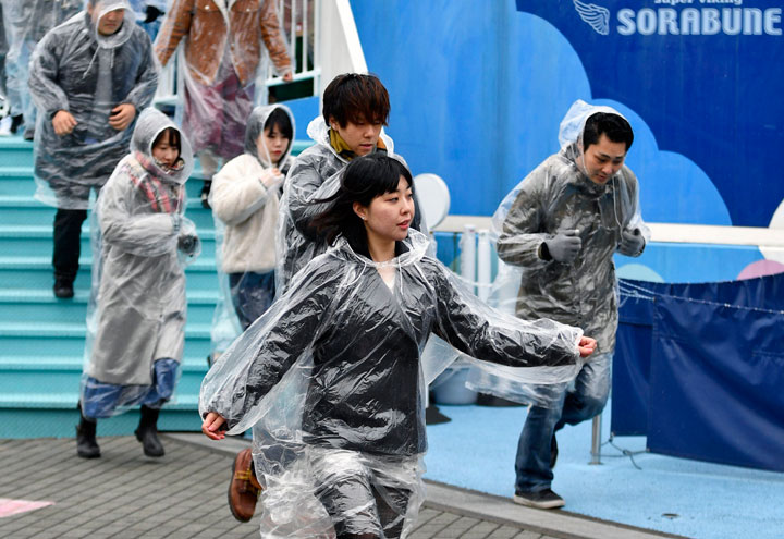 People participate at a missile evacuation drill at an amusement park near Tokyo Dome stadium in Tokyo, Japan, 22 January 2018. Some 250 people participated at the exercise which was the first organised in central Tokyo, based on the scenario that a ballistic missile was heading towards Japan.