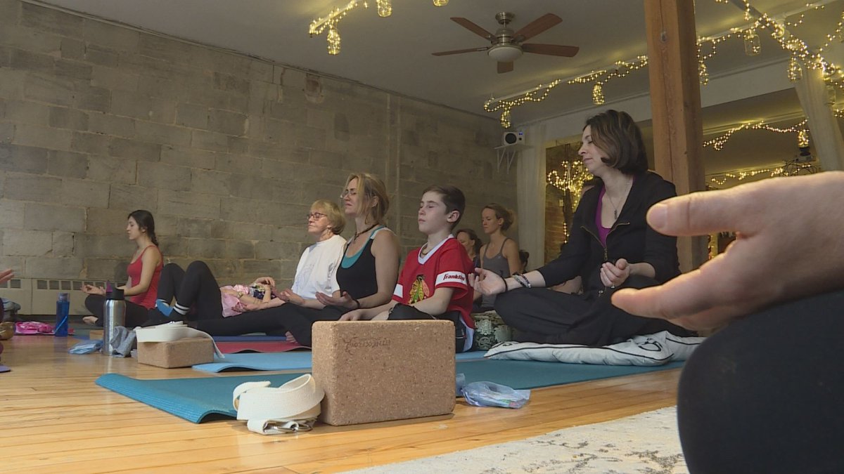 Participants at a yoga fundraiser for Dans la rue, at Land Within Atterrissage Intérieur in Old Montreal, Sunday, January 21, 2018.