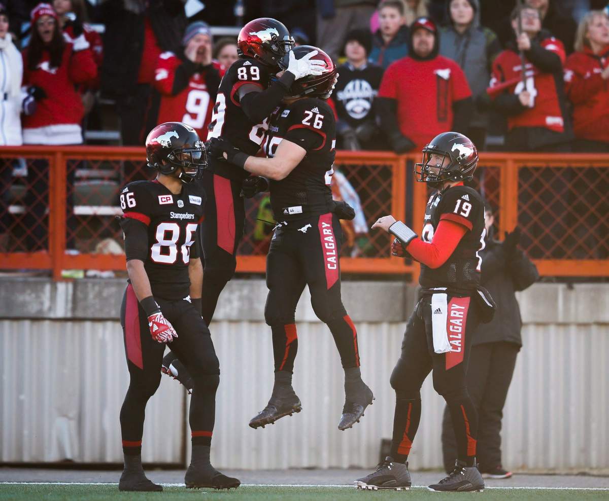 Calgary Stampeders' DaVaris Daniels, centre left, celebrates his touch down with teammates, left to right, Anthony Parker, Rob Cote, and quarterback Bo Levi Mitchell during second quarter CFL Western Final football action against the B.C. Lions in Calgary, Sunday, Nov. 20, 2016.