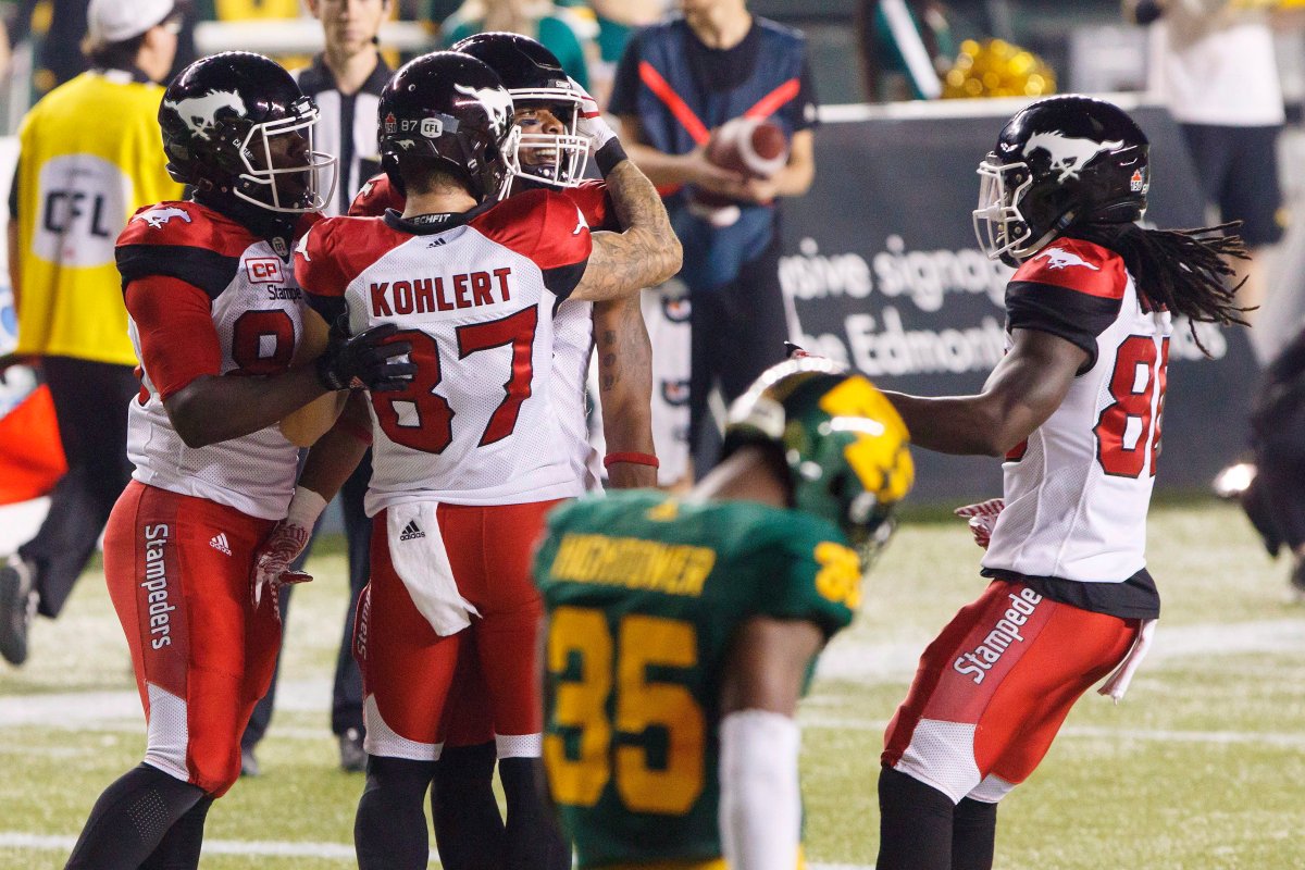 Calgary Stampeders' Marquay McDaniel (16) celebrates his game-winning touchdown with Julan Lynch (85) Rory Kohlert (87), and Marken Michel (80) as Edmonton Eskimos' Forrest Hightower leaves the field during second half CFL action in Edmonton, Alta., on Saturday September 9, 2017.