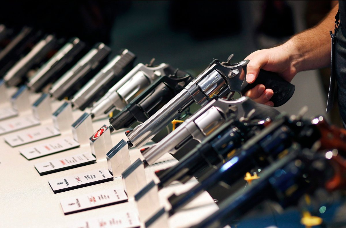FILE - In this Jan. 19, 2016 file photo, handguns are displayed at the Smith & Wesson booth at the Shooting, Hunting and Outdoor Trade Show in Las Vegas. Backers of an expanded gun background check ballot measure approved by Nevada voters in 2016 are arguing that the Nevada governor and attorney general are wrong to say they can't enforce the law.