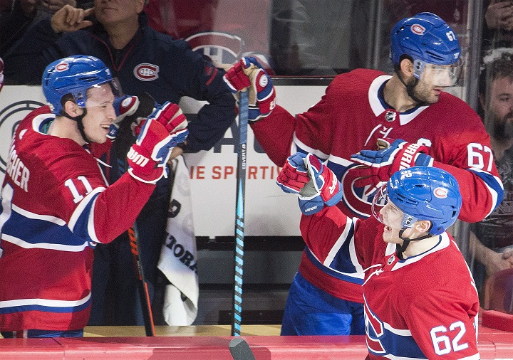 Montreal Canadiens left wing Artturi Lehkonen (62) celebrates with teammates right wing Brendan Gallagher (11) and left wing Max Pacioretty (67) after scoring against the Ottawa Senators during second period NHL hockey action in Montreal, Sunday, February 4, 2018. THE CANADIAN PRESS/Graham Hughes.