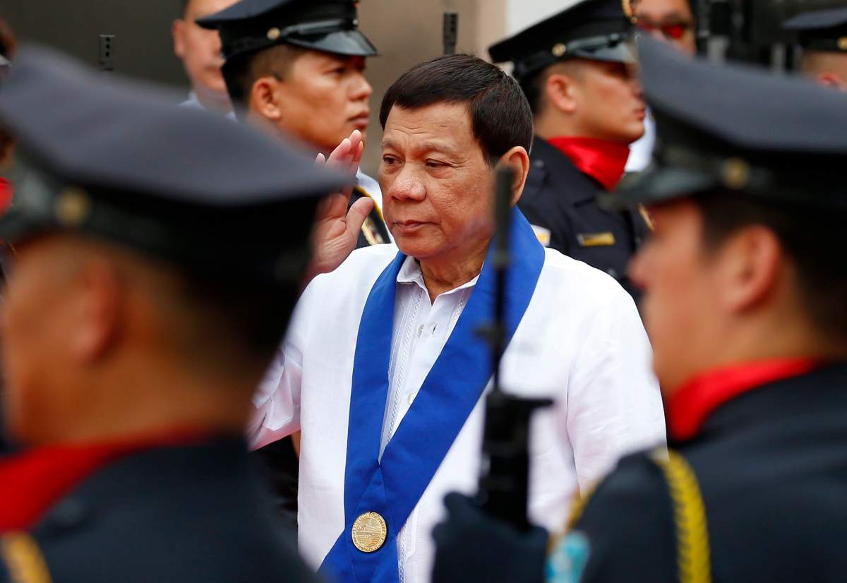 Philippine President Rodrigo Duterte salutes customs police as he arrives to witness the destruction of a fleet of 20 used luxury cars and SUVs as part of the 116th anniversary celebration of the Bureau of Customs in Manila, Philippines Tuesday, Feb. 6, 2018. President Rodrigo Duterte has ordered a stop to all foreign scientific research missions in a vast expanse of waters off the country's northeast and asked navy ships and air force planes to "chase out" fishing and research vessels in the region, an official said Tuesday.