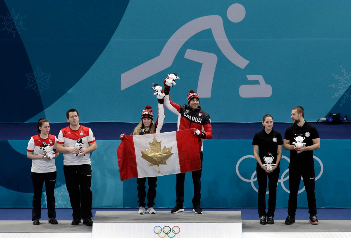 Kaitlyn Lawes and John Morris celebrate winning gold at the Pyeongchang Winter Olympics.
