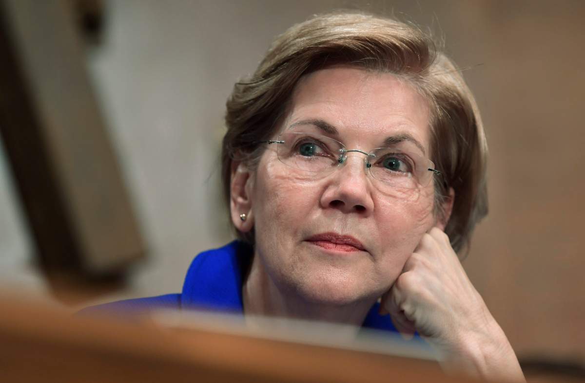 FILE- In this Dec. 5, 2017, file photo, Sen. Elizabeth Warren, D-Mass., waits to speak during a meeting of the Senate Banking Committee on Capitol Hill in Washington. 