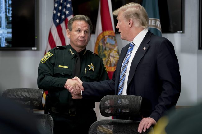 President Donald Trump shakes hands with Broward County Sheriff Scott Israel in Pompano Beach, Fla.,Feb. 16, 2018, following Wednesday's shooting at Marjory Stoneman Douglas High School, in Parkland, Fla. 