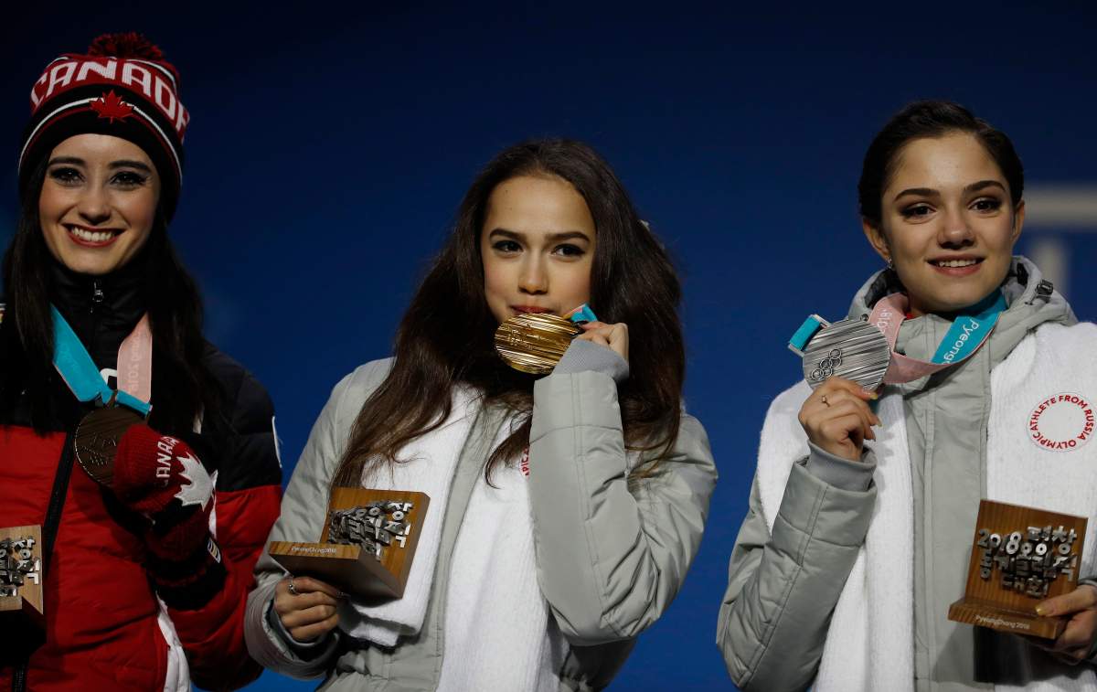 Medalists in the women’s free figure skating, from right, Russian athlete Evgenia Medvedeva, silver, Russian athlete Alina Zagitova, gold, and Canada’s Kaetlyn Osmond, bronze, pose during their medals ceremony at the 2018 Winter Olympics in Pyeongchang, South Korea, Friday, Feb. 23, 2018.