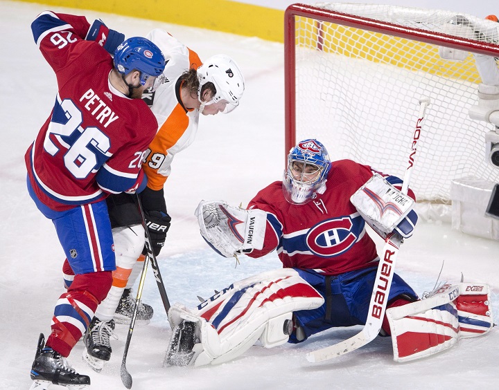 Montreal Canadiens goaltender Charlie Lindgren (39) makes the save on Philadelphia Flyers centre Nolan Patrick (19) as Montreal Canadiens defenceman Jeff Petry (26) moves in during third period NHL hockey action Monday, February 26, 2018 in Montreal. 