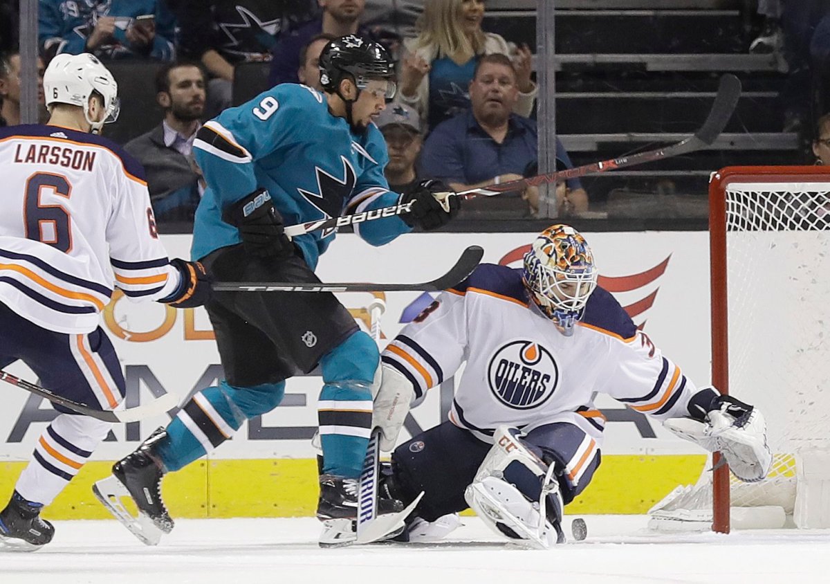 Edmonton Oilers goaltender Cam Talbot, right, stops a shot from San Jose Sharks' Evander Kane during the first period of an NHL hockey game Tuesday, Feb. 27, 2018, in San Jose, Calif. (AP Photo/Marcio Jose Sanchez).