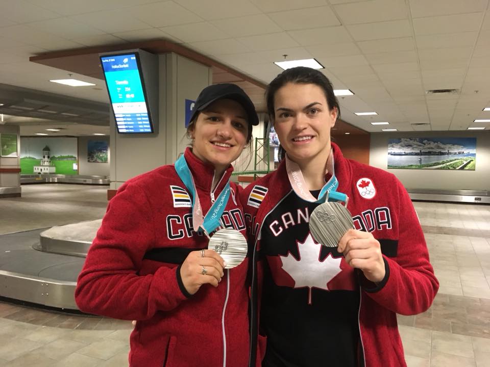 Team Canada hockey players Jill Saulnier and Blayre Turnbull are seen showing off their silver medals after the 2018 PyeongChang Olympics. The two Nova Scotians are competing in this year's Games in Beijing.