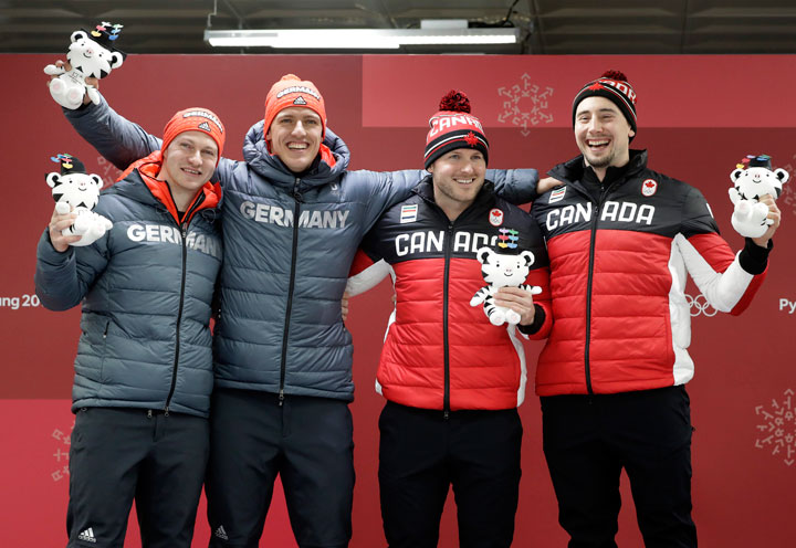From left, tied gold medalists Driver Francesco Friedrich and Thorsten Margis of Germany and Driver Justin Kripps and Alexander Kopacz of Canada celebrate during the two-man bobsled final at the 2018 Winter Olympics in Pyeongchang, South Korea, Monday, Feb. 19, 2018.