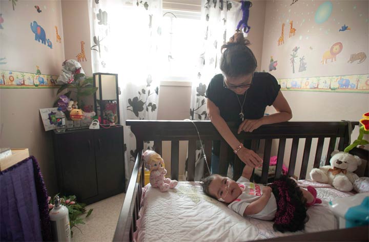 Josie Ledoux spends some time with her granddaughter Aurora in her deceased daughter's old bedroom in Prince Albert, Sask. on Saturday, July 12,2014.