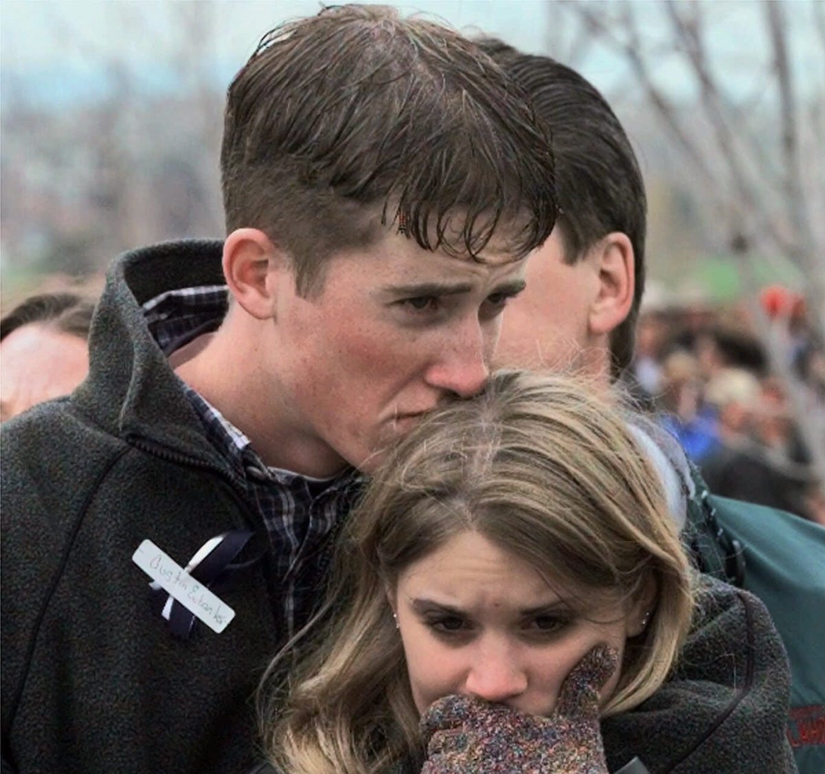FILE - In this Sunday, April 25, 1999 file photo, shooting victim Austin Eubanks hugs his girlfriend during a community wide memorial service in Littleton, Colo., for the victims of the shooting rampage at Columbine High School the previous week. 